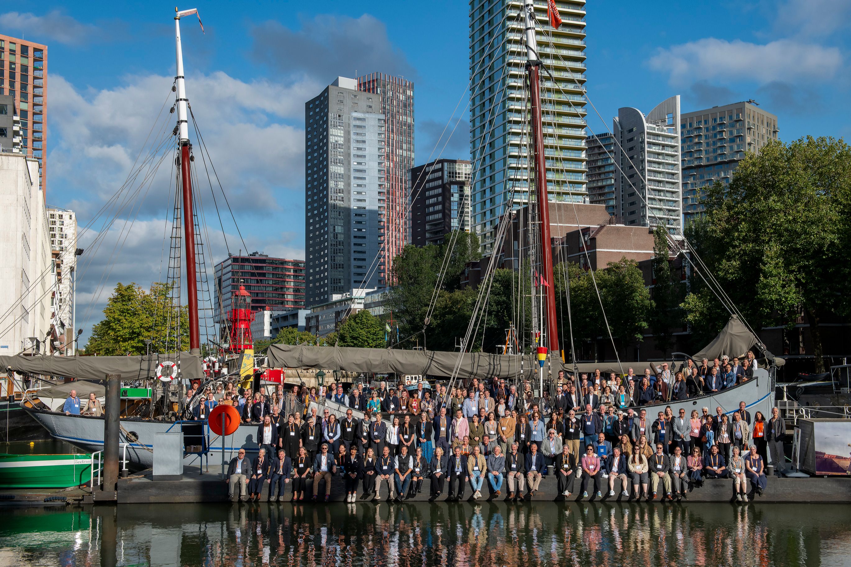 Photo of a large group of people standing on and around a ship.