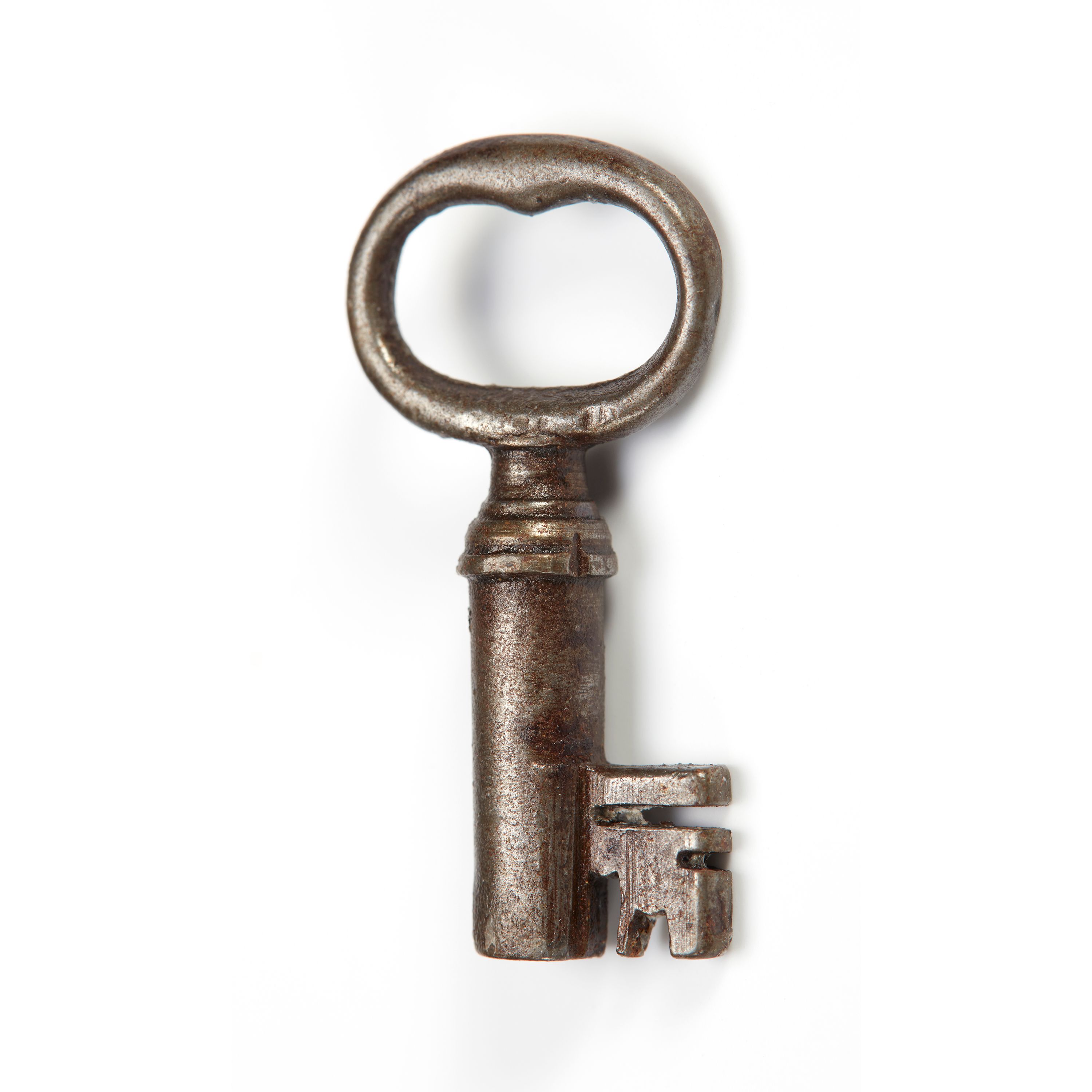Photo of an old, metal key on a white background.