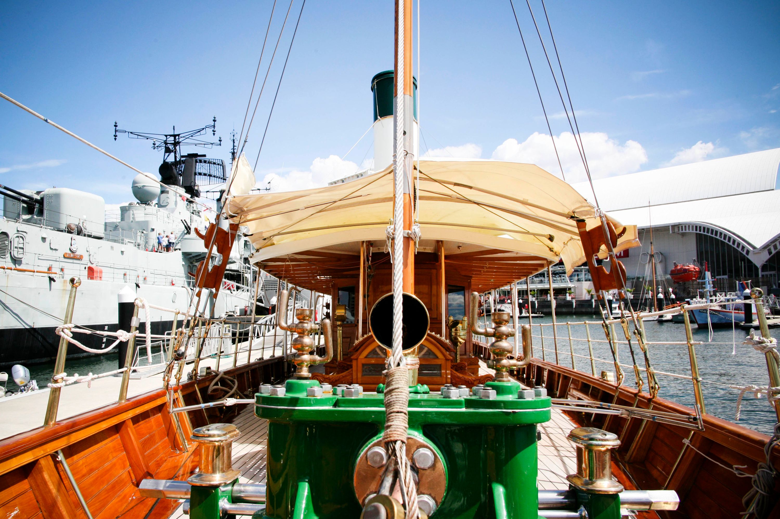 Photo looking from the front of a wooden steam yacht down the deck.