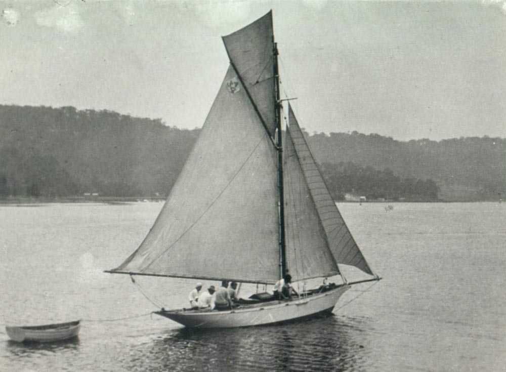 Black and White Photograph of a small sailing boat with white sails.
