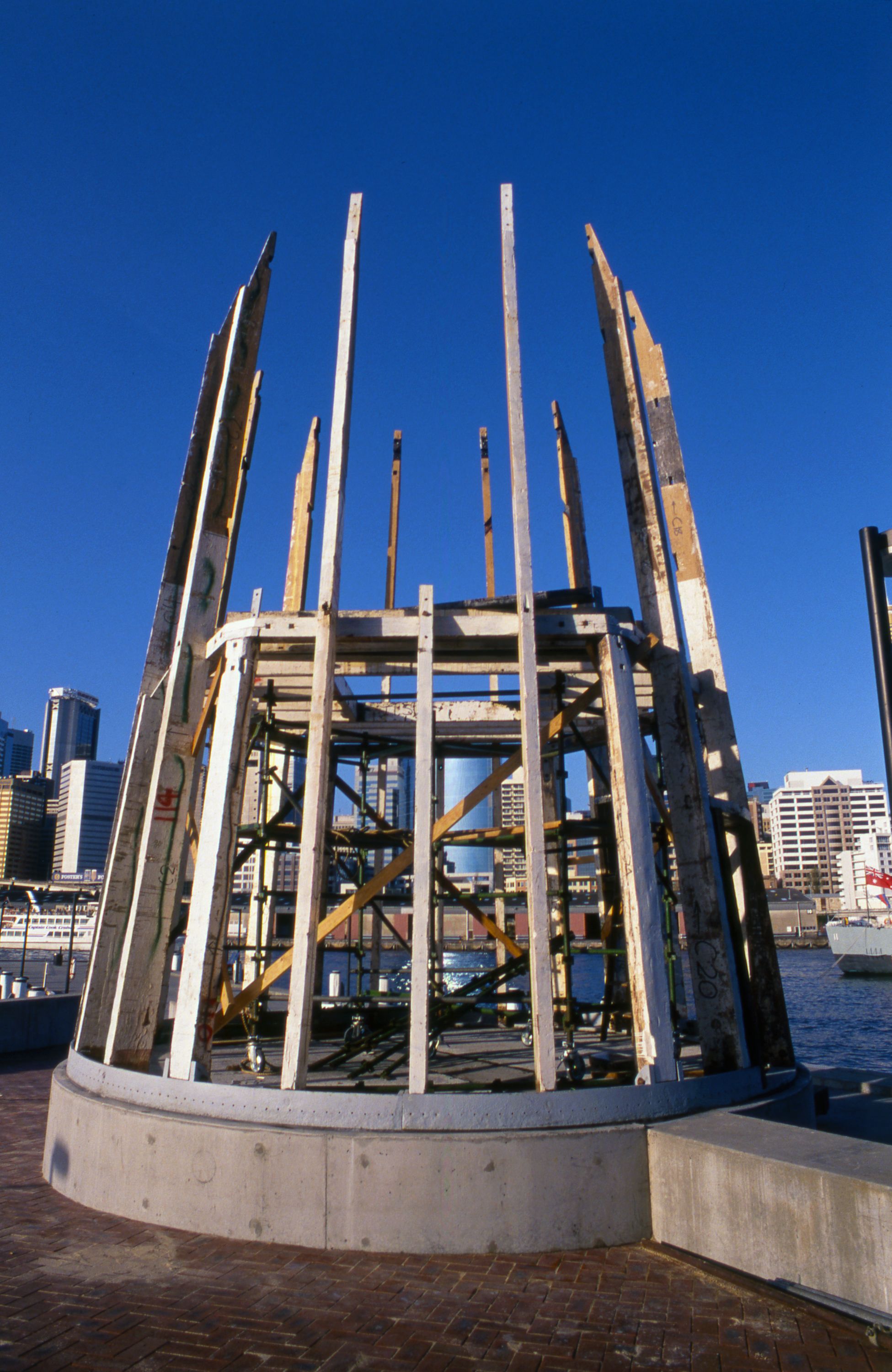 Photo showing the base of a lighthouse being reconstructed. 