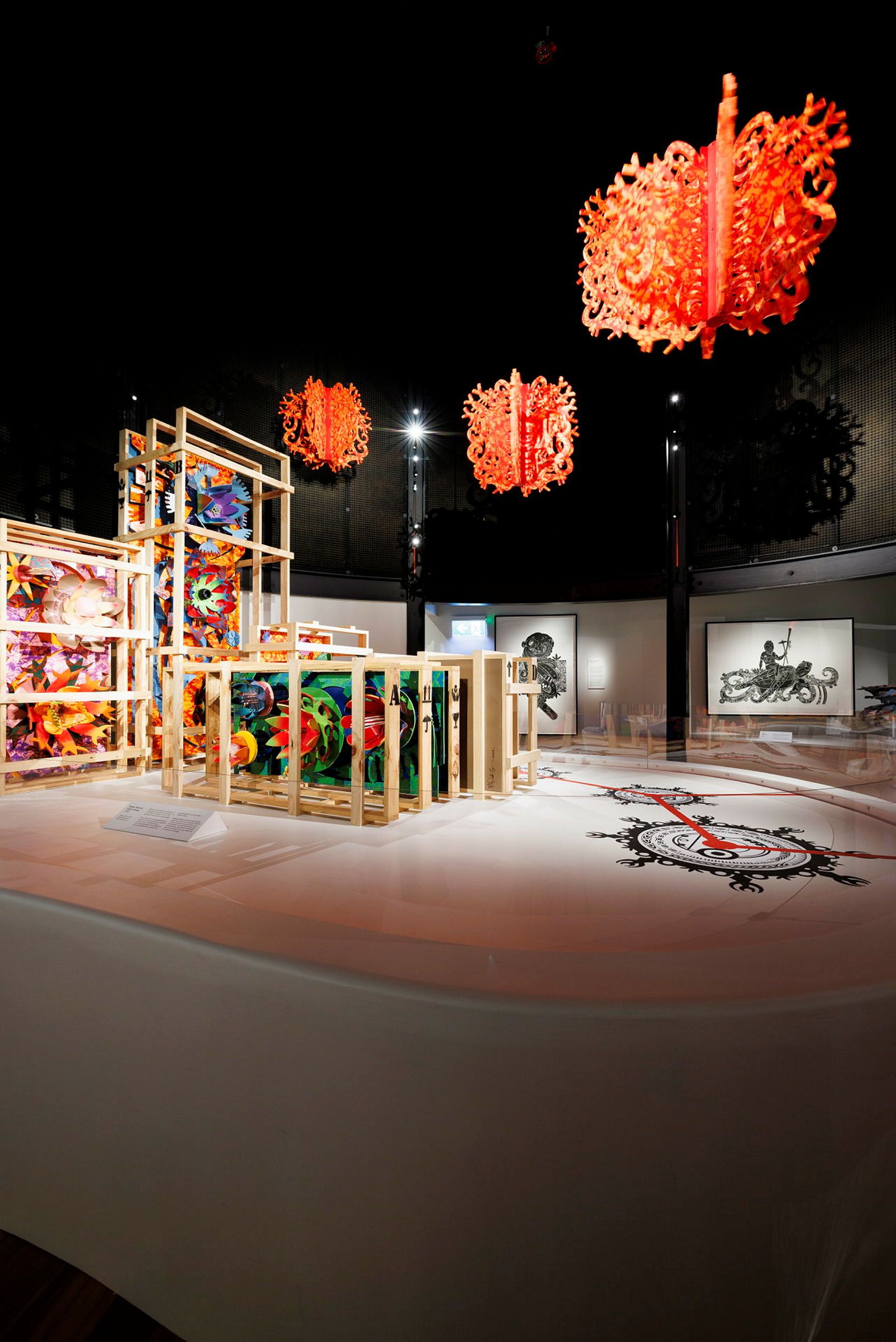 Photo of a museum exhibition space with colourful, patterned sculptures. 